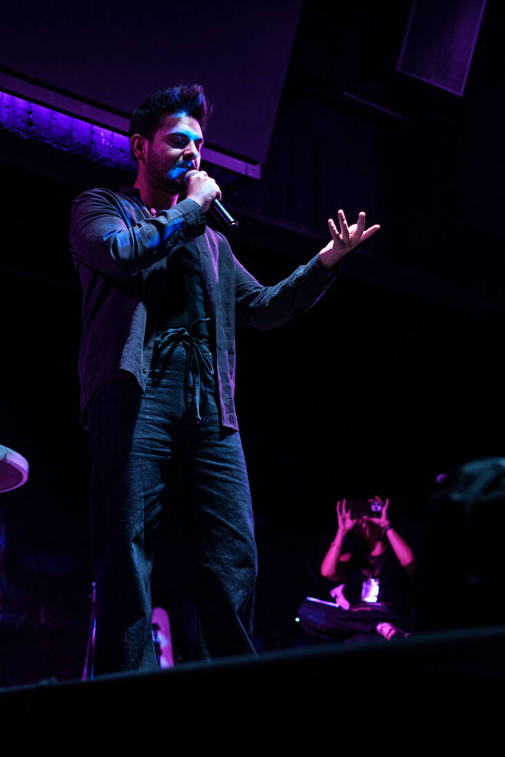 Pedro Parlo cantando con el brazo extendido